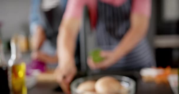 Önlüklü Sebze Hazırlayan Mutfakta Konuşan Farklı Çiftlerin Orta Kesimi Yavaş — Stok video