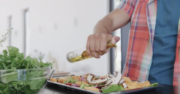 Félidős Férfi Ételt Készít Olajat Önt Zöldségekre Napsütötte Konyhában Lassított — Stock videók