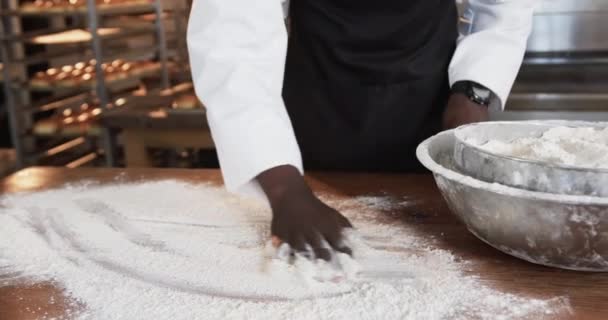 African American Male Baker Working Bakery Kitchen Spreading Flour Counter — Stock Video