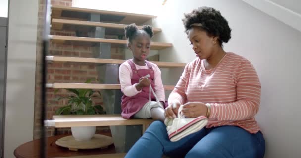 African American Mother Advising Tying Shoes Daughter Home Slow Motion — Stock Video