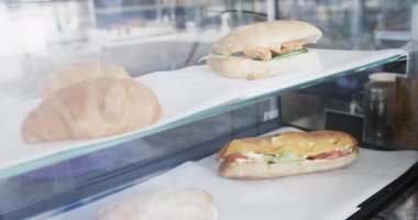 Taze ve lezzetli kruvasanları ve sandviçleri fırında yavaş çekimde cam üzerine kapatın. İş, fırın ve yemek..