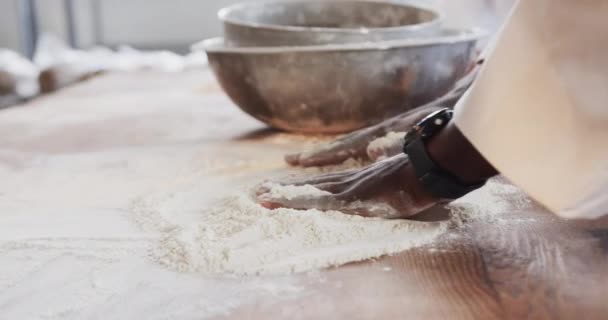 African American Male Baker Working Bakery Kitchen Spreading Flour Counter — Stock Video