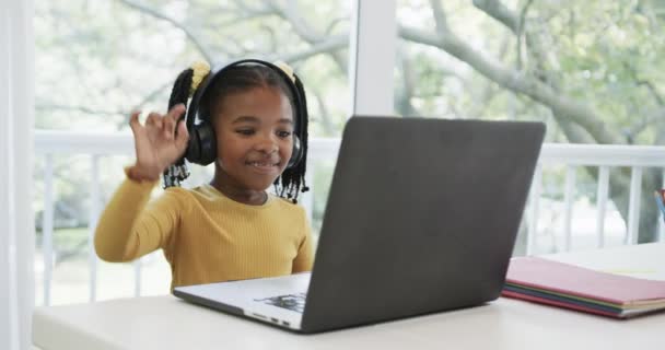 Happy African American Girl Using Laptop Headphones Raising Hand Online — kuvapankkivideo