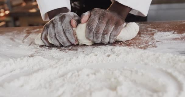 African American Male Baker Working Bakery Kitchen Kneading Dough Counter — Stock Video