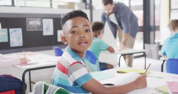 Porträt Eines Afrikanisch Amerikanischen Schuljungen Der Klassenzimmer Lächelt Und Schreibt — Stockvideo