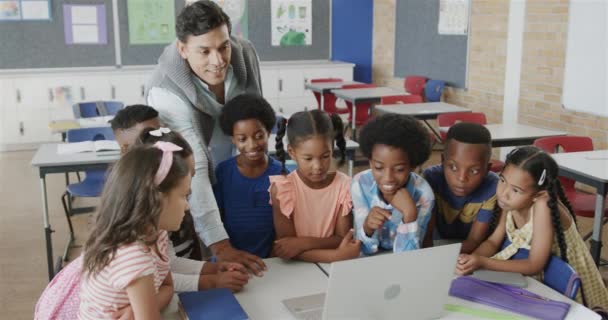 Happy Diverse Male Teacher Children Using Laptop Elementary School Class — kuvapankkivideo