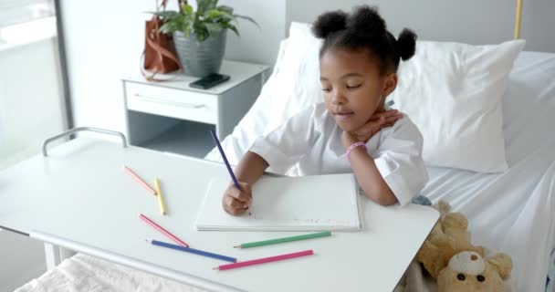 African American Girl Drawing Notebook Hospital Bed Slow Motion Medicine — kuvapankkivideo