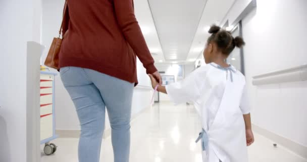 African American Mother Daughter Hospital Gown Holding Hands Walking Corridor — стокове відео