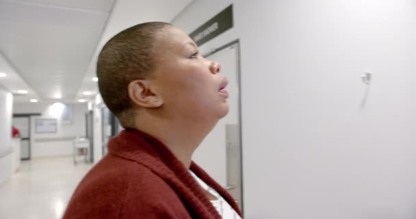 Stressed African American Woman Using Smartphone Hospital Corridor Slow Motion — Vídeos de Stock