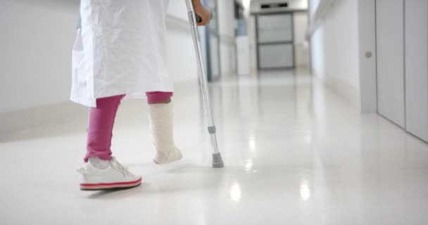 Lowsection African American Girl Hospital Gown Walking Using Crutches Corridor — Stock video