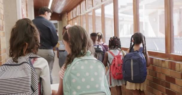 Happy Diverse Male Teacher Children Bags Walking Elementary School Corridor — Stockvideo