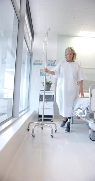 Vertical Video Caucasian Female Patient Prosthetic Leg Walking Holding Stand — Stockvideo