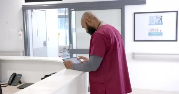 African American Male Doctor Using Tablet Hospital Reception Slow Motion — Stockvideo