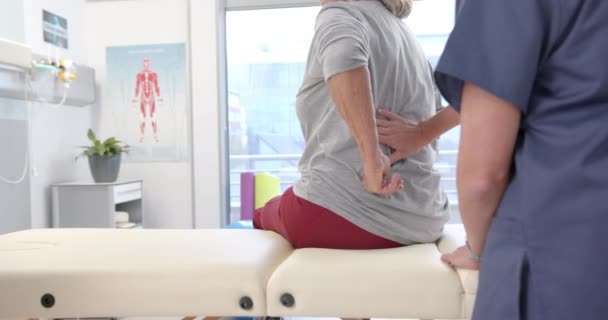 Caucasian Female Physiotherapist Massaging Lower Back Female Senior Patient Rehab — Stockvideo