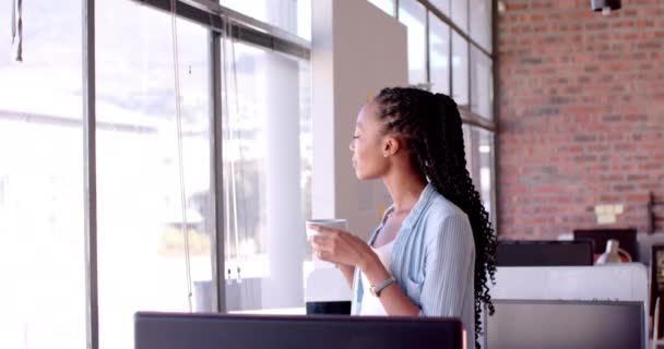 African American Casual Businesswoman Drinking Coffee Looking Out Window Office — Stock Video