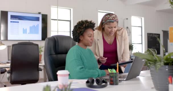 不同的商界女同事在办公室里讨论使用平板电脑和笔记本电脑 动作缓慢 临时办公室 团队精神 沟通和工作 — 图库视频影像