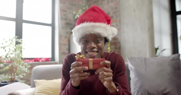 Happy African American Man Wearing Santa Hat Sitting Sofa Having — Stock Video