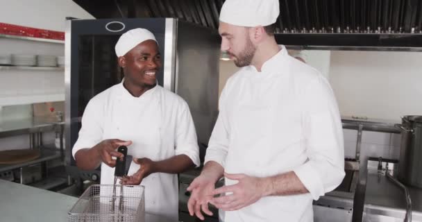 Skupiony Zróżnicowany Kucharz Męski Instruowanie Praktykanta Kuchni Męskiej Zwolnionym Tempie — Wideo stockowe