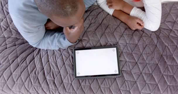 Africký Americký Otec Syn Ležící Posteli Pomocí Tabletu Kopírovacím Prostorem — Stock video