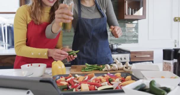 Happy Caucasian Lesbian Couple Preparing Food Using Tablet Sunny Kitchen — Stock Video