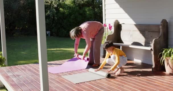 Großmutter Und Enkel Rollen Yogamatten Auf Der Terrasse Zeitlupe Familie — Stockvideo
