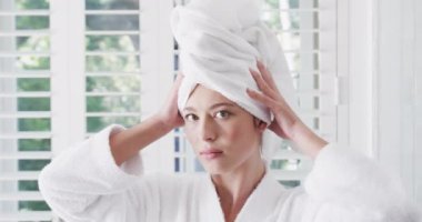 Çift ırklı bir kadın çalışıyor ve evde tek başına vakit geçiriyor, ağır çekimde. Kişisel bakım, yaşam tarzı ve ev hayatı, değişmedi..