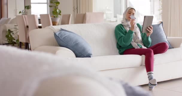 Femme Naissante Dans Hijab Utilisant Une Tablette Sur Canapé Maison — Video