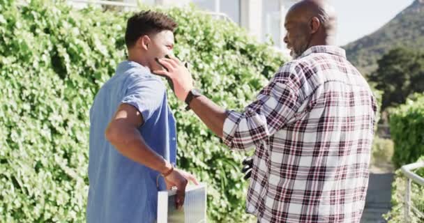African American Father Talking Adult Son Holding Solar Panel Sunny — Stock Video
