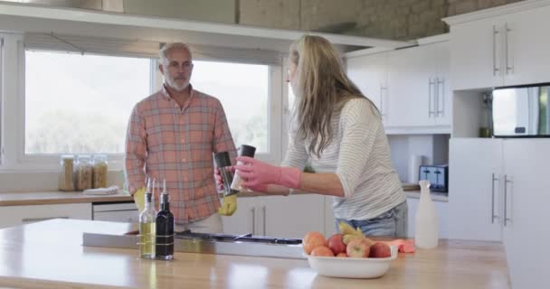 中年白人夫妇在家里打扫厨房 动作缓慢 房屋唱诗班 生活方式和家庭生活 复制空间 — 图库视频影像