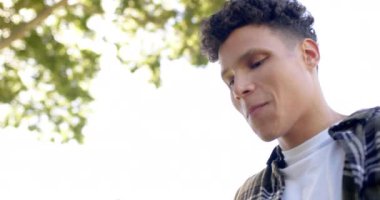 Güneşli bahçede ağır çekimde baloncuk çıkaran mutlu çift ırklı adam. Yaşam tarzı, yaz ve doğa, değişmemiş..