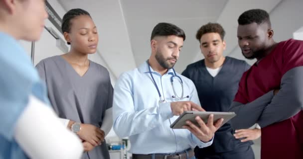 Diverse Male Female Doctors Discussing Work Using Tablet Hospital Corridor — Stock Video