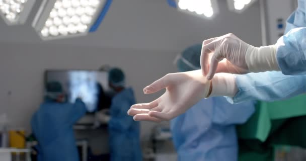 Midsection African American Surgeon Wearing Surgical Gloves Operating Theatre Slow — Stock Video