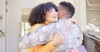 Mutlu Afro-Amerikan erkek askeri evinde kızını ve karısını kucaklıyor, ağır çekimde. Aile hayatı, vatanseverlik ve aile, değişmemiş..