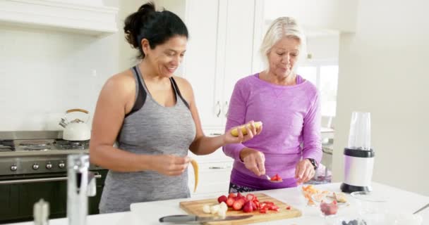 Two Happy Diverse Senior Women Preparing Fruits Laughing Sunny Kitchen — Stock Video