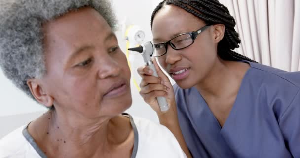Afroamerykanka Lekarz Badający Słuch Starszej Pacjentki Szpitalu Zwolniony Ruch Medycyna — Wideo stockowe