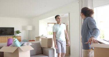 Yeni evlerinde kutuları, fotokopi alanı ve ağır çekimle kucaklaşan mutlu eşcinsel çift. Ev, taşınma, gey, ilişki, birliktelik, ev hayatı ve yaşam tarzı, değişmemiş..