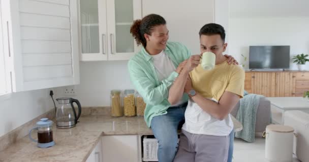 Happy Diverse Gay Male Couple Having Coffee Embracing Kitchen Copy — Stock Video