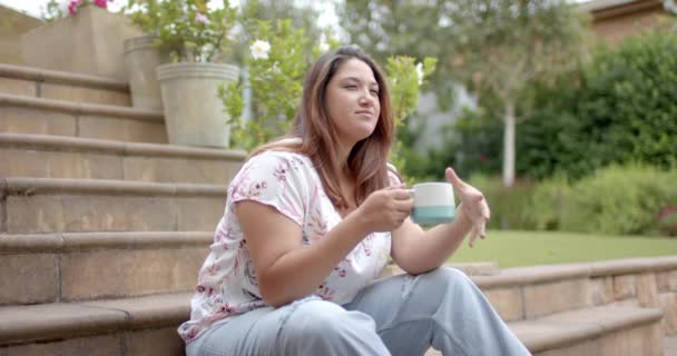 Happy Size Biracial Woman Sitting Steps Garden Drinking Coffee Copy — Stock Video