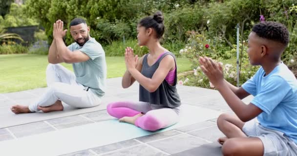 Afro Amerikaanse Vader Onderwijst Zoon Dochter Yoga Meditatie Zittend Tuin — Stockvideo