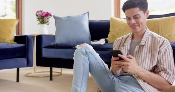 Happy Biracial Man Duduk Lantai Menggunakan Smartphone Ruang Tamu Salinan — Stok Video