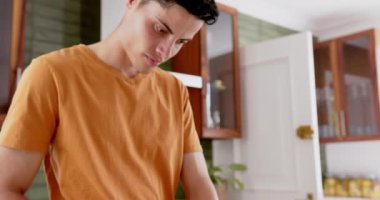 Meyve doğramaya odaklanmış bir adam, mutfakta sağlıklı meyve suyu hazırlıyor, fotokopi alanı, ağır çekim. Yiyecek, beslenme, refah ve sağlıklı yaşam tarzı, değişmemiş..