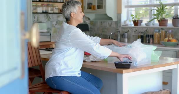 Happy Senior Biracial Woman Segregating Plastic Waste Home Slow Motion — Stock Video