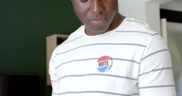 Młody Afroamerykanin Odznaką Głosuj Stoi Domach Promując Znaczenie Uczestnictwa Obywatelskiego — Wideo stockowe