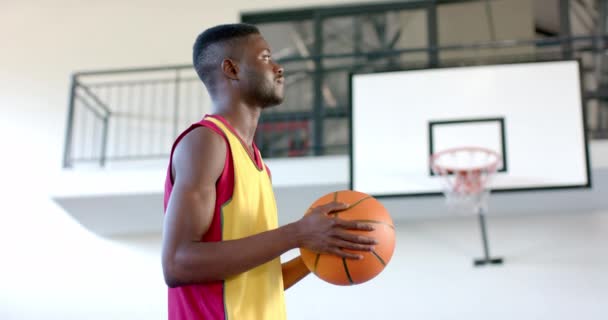 非裔美国人在体育馆里打篮球 他把注意力集中在比赛上 准备任意球 慢动作 — 图库视频影像