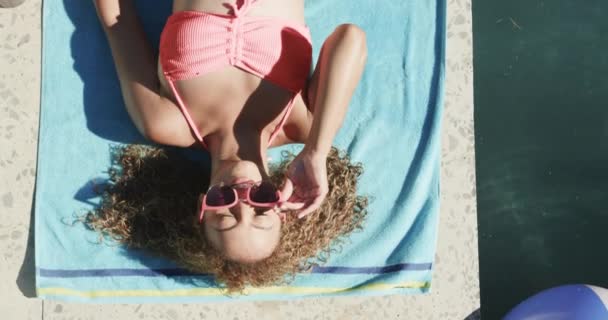 Mujer Biracial Joven Disfruta Del Sol Junto Piscina Pose Relajada — Vídeos de Stock