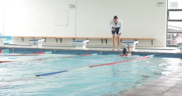 Swimming Coach Giving Instructions Poolside Copy Space Indoor Swimming Pool — Stock Video