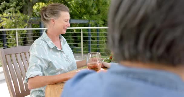 Senior Biracial Woman Enjoys Conversation Outdoors Relaxed Gathering Wine Adds — Stock Video