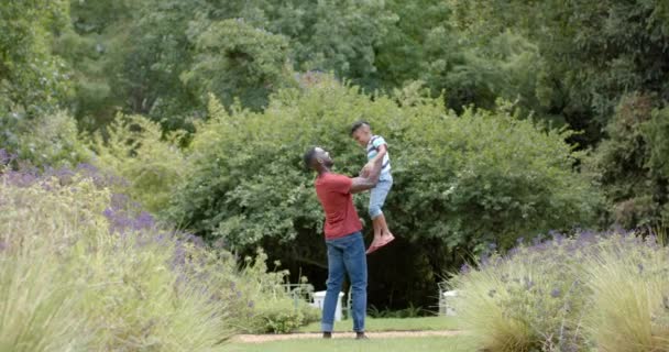 African American Father Holds His Son Loving Embrace Outdoors Home — Stock Video