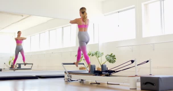 Jonge Blanke Vrouw Oefent Een Pilates Hervormer Een Heldere Studio — Stockvideo