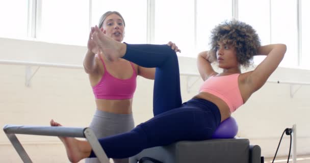 Two Women Engage Pilates Workout Reformer Machine Bright Fitness Studio — Stock Video